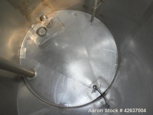 Used Tank, 825 Gallon, 304 Stainless Steel, Vertical. Approximately 55-1/2" diameter x 80" straight side, flat top, sloped bottom. Openings top 1-1/2" tri-clamp, (2) 3" tri-clamp, (2) 3", (2) 4-1/2",...