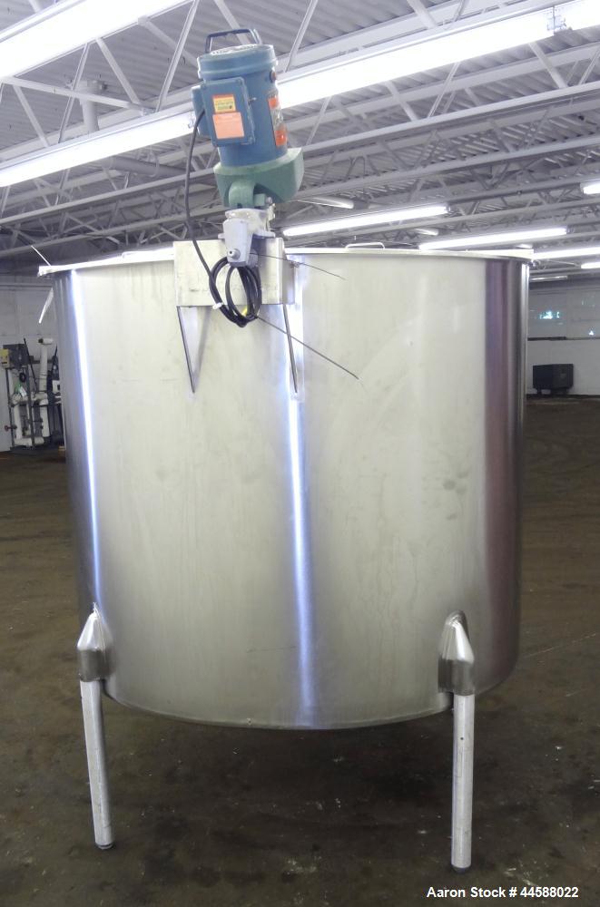 Used Perma-San Tank, 650 Gallons, Model OVS, 316 Stainless Steel, Vertical. Approximately 62" diameter x 51" straight side, open top with (2) 1/3 covers, sloped bottom. Lightnin clamp-on agitator, mo...