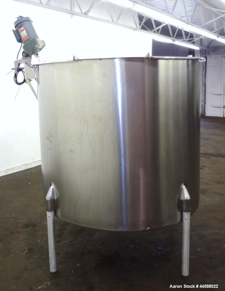Used Perma-San Tank, 650 Gallons, Model OVS, 316 Stainless Steel, Vertical. Approximately 62" diameter x 51" straight side, open top with (2) 1/3 covers, sloped bottom. Lightnin clamp-on agitator, mo...
