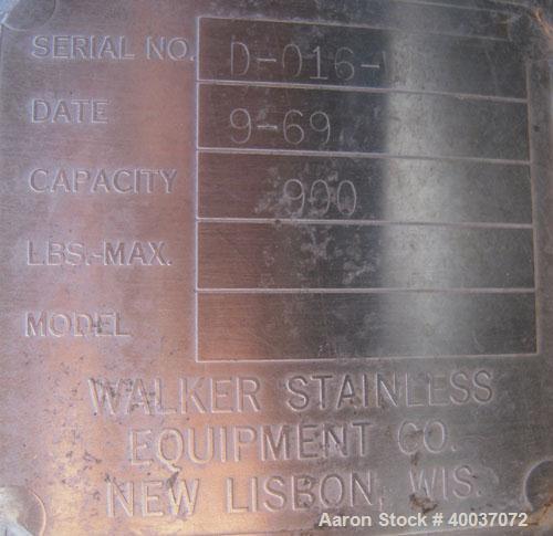 Used Walker Stainless Tank, 900 Gallon, Stainless Steel, vertical. Approximately 60" diameter x 72" straight side, dished top and bottom. Internal rated 75 psi at 325 deg F. Lightnin agitator model 7...