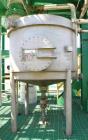 Used Tank, Approximate 500 Gallon, Stainless Steel, Vertical. Approximate 60” diameter x 48” straight side, coned top and bottom. Side man way, center bottom outlet. Mounted on (4) stainless steel le...