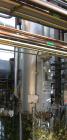 USED: Walker approximate 550 gallon, T304L stainless steel, tank. Approximately 3' diameter x 10' straight side. Dished heads. Miscellaneous side and top openings. 3