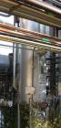 USED: Walker approximate 550 gallon, T304L stainless steel, tank. Approximately 3' diameter x 10' straight side. Dished heads. Miscellaneous side and top openings. 3