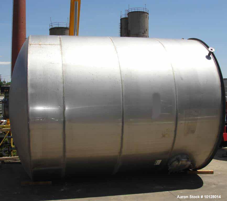 Used 12,000 Gallon Vertical Stainless Steel Tank. Dome Top and Sloped Bottom. Diameter is 144", Height 174", dome is 20", straight side height 168". Top has 22" manway and (3) 3 " flanges. Side has 2...