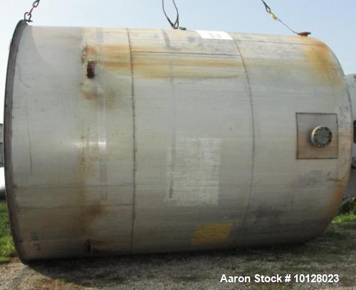 Used 11,900 Gallon Vertical Stainless Steel Tank. Interior dimensions 140" diameter x 175" tall, open top, sloped bottom with a 5" flanged outlet that drops down and out to the side. Side has a 6" fl...