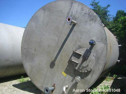 Used-approximate 10,000 gallon vertical 304 stainless steel tank with flat bottom head.