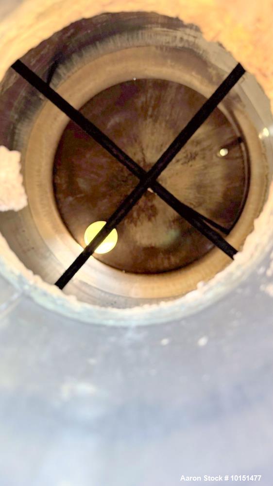 Used Stainless Steel Tank.  Approximately 7,000 gallon; 9' diameter x 15' straight side; Vetical; Slight coned top and bottom; Approximately 4" center bottom outlet; on (6) stainless steel legs.