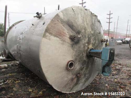Used 12,000 Gallon, 304 Stainless Steel Tank. 12' diameter x 16' straight side; 4' carbon steel skirt. Dished ends, 24" side bottom manway with top entering 2 tier 3 blade turbine style Chemineer agi...