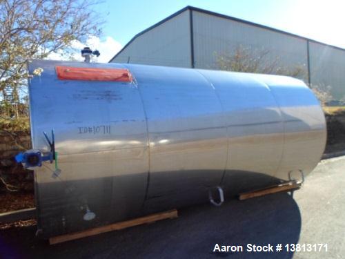 Used 6000 Gallon Stainless Steel Storage Tank. Approximately 94'' diameter, 16' straight wall, side manhole.  Inlets 3-1.5'' threaded 2-3''. Outlets 3'' bolt flange. Tank has large dent in top.