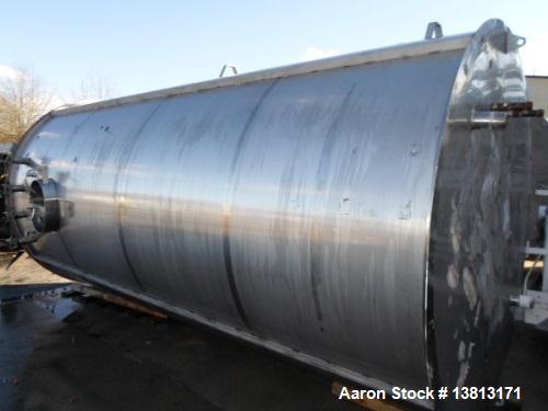 Used 6000 Gallon Stainless Steel Storage Tank. Approximately 94'' diameter, 16' straight wall, side manhole.  Inlets 3-1.5'' threaded 2-3''. Outlets 3'' bolt flange. Tank has large dent in top.