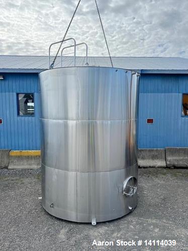 Unused- 6,600 Gallon 304 Stainless Steel Tank. (24,984 Liters) Interior Dimensions: 9'6" diameter x 12' straight side. Top and bottom side manways with lids. CIP Spray Ball. Top side inlets 2" Tri-cl...