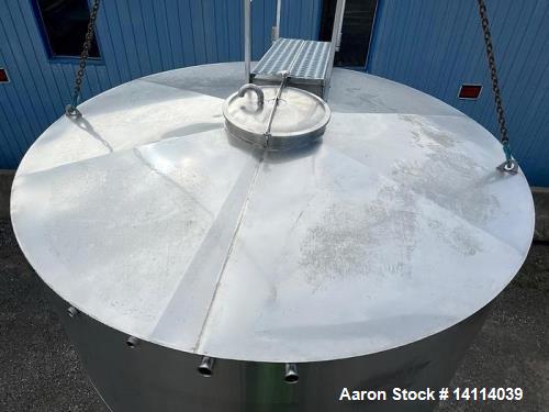 Unused- 6,600 Gallon 304 Stainless Steel Tank. (24,984 Liters) Interior Dimensions: 9'6" diameter x 12' straight side. Top and bottom side manways with lids. CIP Spray Ball. Top side inlets 2" Tri-cl...