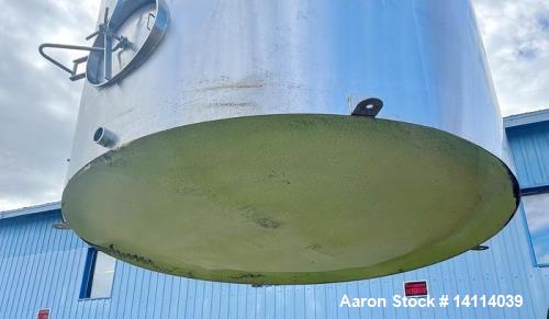 Unused- 6,600 Gallon 304 Stainless Steel Tank. (24,984 Liters) Interior Dimensions: 9'6" diameter x 12' straight side. Top and bottom side manways with lids. CIP Spray Ball. Top side inlets 2" Tri-cl...