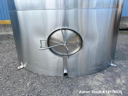Unused- 6,600 Gallon 304 Stainless Steel Tank. (24,984 Liters) Interior Dimensions: 9'6" diameter x 12' straight side. Top and bottom side manways with lids. CIP Spray Ball. Top side inlets 2" Tri-cl...
