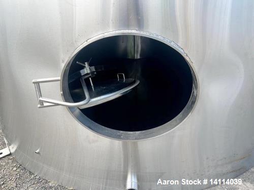 Unused- 6,600 Gallon 304 Stainless Steel Tank. (24,984 Liters) Interior Dimensions: 9'6" diameter x 12' straight side. Top and bottom side manways with lids. CIP Spray Ball. Top side inlets 2" Tri-cl...