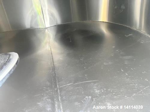 Unused- 6,600 Gallon 304 Stainless Steel Tank. (24,984 Liters) Interior Dimensions: 9'6" diameter x 12' straight side. Top and bottom side manways with lids. CIP Spray Ball. Top side inlets 2" Tri-cl...