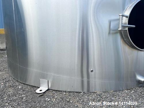 Unused- 6,600 Gallon 304 Stainless Steel Tank. (24,984 Liters) Interior Dimensions: 9'6" diameter x 12' straight side. Top and bottom side manways with lids. CIP Spray Ball. Top side inlets 2" Tri-cl...