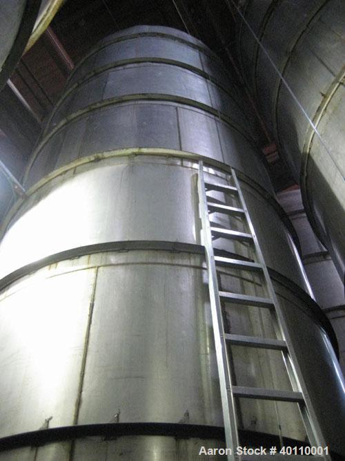 Used: Westeel 17,196 Gallon (65,000 Liter) 304 Stainless Steel Storage Tank. Vertical Design. Approx. 10' Diameter x 31'6"  Long. Slight Cone Top and Sloping Bottom having a 4-1/2" Pitch. Top head ha...