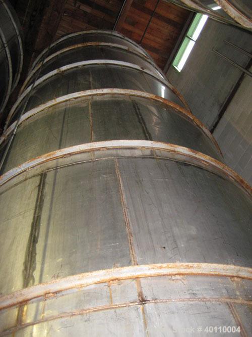 Used Westeel 17,196 Gallon (65,000 Liter) 304 Stainless Steel Storage Tank. Vertical Design. Approx. 10' Diameter x 31'6"  Long. Slight Cone Top and Sloping Bottom having a 4 1/2" Pitch. Top head has...