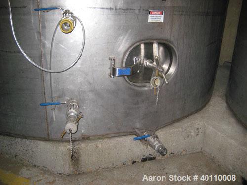 Used Westeel 25,608 Gallon (96,800 Liter) 304 Stainless Steel Storage Tank. Vertical Design. Approx. 12' Diameter x 31'6"  Long. Slight Cone Top and Sloping Bottom having a 4 1/2" Pitch. Top head has...