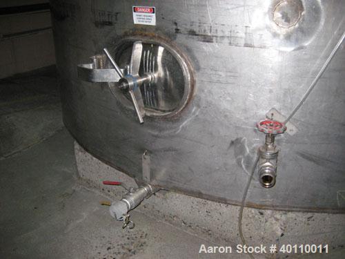Used Westeel 25,608 Gallon (96,800 Liter) 304 Stainless Steel Storage Tank. Vertical Design. Approx. 12' Diameter x 31'6"  Long. Slight Cone Top and Sloping Bottom having a 4 1/2" Pitch. Top head has...