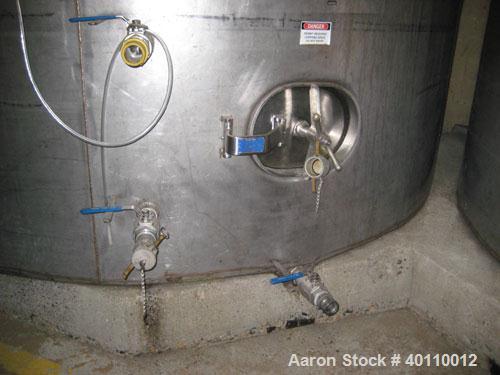 Used Westeel 25,608 Gallon (96,800 Liter) 304 Stainless Steel Storage Tank. Vertical Design. Approx. 12' Diameter x 31'6"  Long. Slight Cone Top and Sloping Bottom having a 4 1/2" Pitch. Top head has...