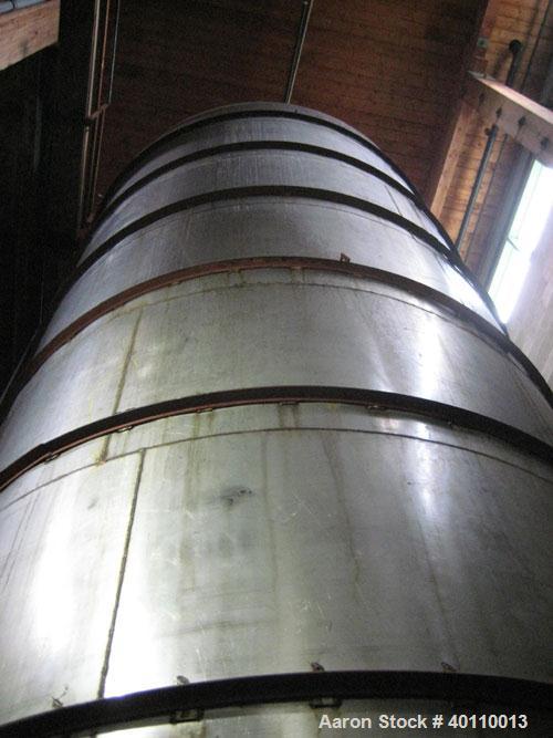 Used Westeel 25,608 Gallon (96,800 Liter) 304 Stainless Steel Storage Tank. Vertical Design. Approx. 12' Diameter x 31'6"  Long. Slight Cone Top and Sloping Bottom having a 4 1/2" Pitch. Top head has...