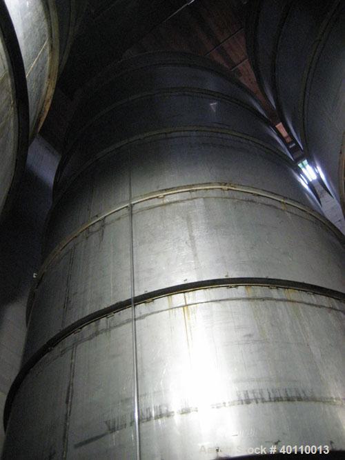 Used Westeel 25,608 Gallon (96,800 Liter) 304 Stainless Steel Storage Tank. Vertical Design. Approx. 12' Diameter x 31'6"  Long. Slight Cone Top and Sloping Bottom having a 4 1/2" Pitch. Top head has...