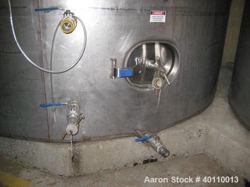 Used Westeel 25,608 Gallon (96,800 Liter) 304 Stainless Steel Storage Tank. Vertical Design. Approx. 12' Diameter x 31'6"  Long. Slight Cone Top and Sloping Bottom having a 4 1/2" Pitch. Top head has...