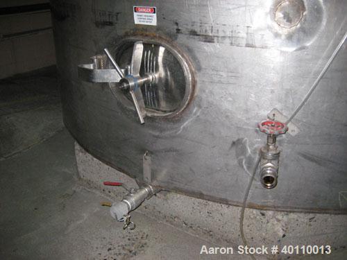 Used Westeel 25,608 Gallon (96,800 Liter) 304 Stainless Steel Storage Tank. Vertical Design. Approx. 12' Diameter x 31'6"  Long. Slight Cone Top and Sloping Bottom having a 4 1/2" Pitch. Top head has...