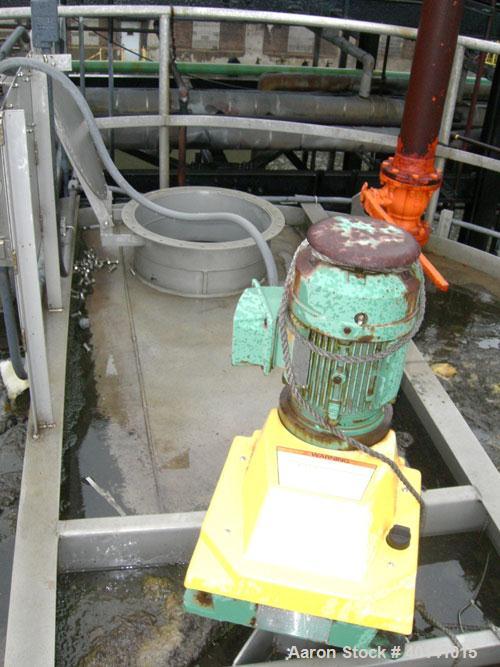 Used: Steel tank and Fabricators tank, 15,000 gallon, 316 L. 1/4" shellL, 12' diameter X 17'6" high, flat top and bottom,  vertical, API standard 650 rating. Top mounted Lightnin agitator, model 15S2...