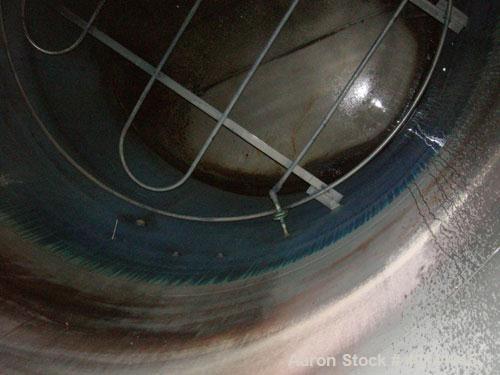 Used: Steel tank and Fabricators tank, 15,000 gallon, 316 L. 1/4" shellL, 12' diameter X 17'6" high, flat top and bottom,  vertical, API standard 650 rating. Top mounted Lightnin agitator, model 15S2...
