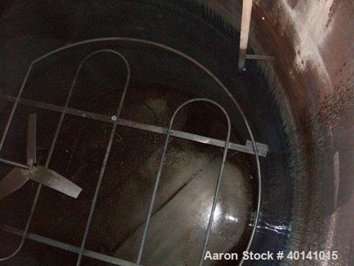 Used: Steel tank and Fabricators tank, 15,000 gallon, 316 L. 1/4" shellL, 12' diameter X 17'6" high, flat top and bottom,  vertical, API standard 650 rating. Top mounted Lightnin agitator, model 15S2...