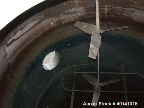 Used: Steel tank and Fabricators tank, 15,000 gallon, 316 L. 1/4" shellL, 12' diameter X 17'6" high, flat top and bottom,  vertical, API standard 650 rating. Top mounted Lightnin agitator, model 15S2...