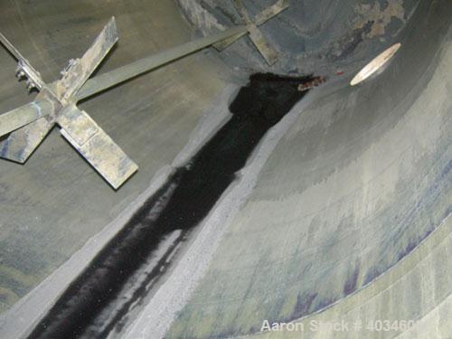 Used Industrial Air Inc Tank, 7,000 gallon, 304 stainless steel, vertical. Approximately 104" diameter x 192" straight side. Flat top and bottom. Carbon steel agitator bridge with an off center top e...