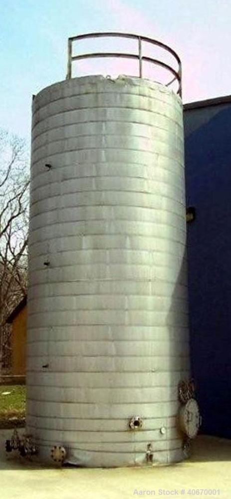 Used 15,000 Gallon insulated stainless steel tank. 3/8" thick 304 stainless steel, 34' tall, 10'6" diameter, multiple fill and discharge ports, access hatch, electrically heated.