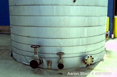 Used 15,000 Gallon insulated stainless steel tank. 3/8" thick 304 stainless steel, 34' tall, 10'6" diameter, multiple fill and discharge ports, access hatch, electrically heated.