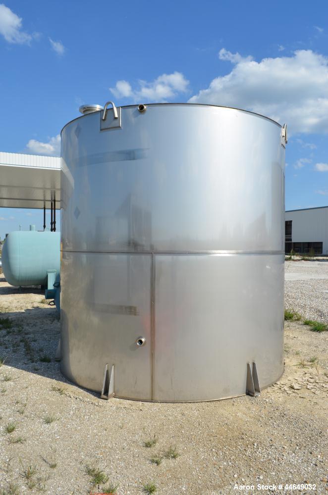 Unused- 5800 Gallon Storage Tank, stainless steel. Approximate 120" diameter x 120" straight side, coned top, flat bottom. Side, and top manways with covers. No manufacturers tag.