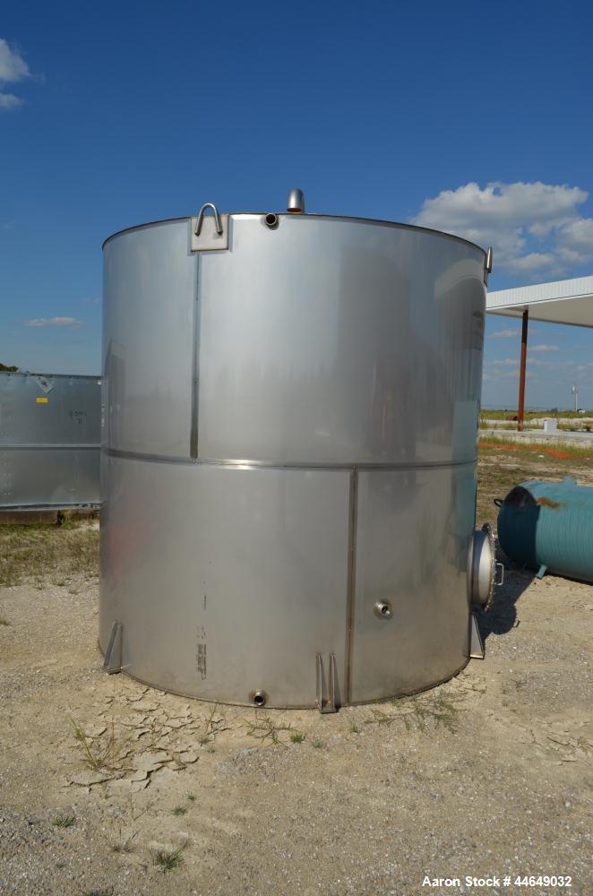 Unused- 5800 Gallon Storage Tank, stainless steel. Approximate 120" diameter x 120" straight side, coned top, flat bottom. Side, and top manways with covers. No manufacturers tag.
