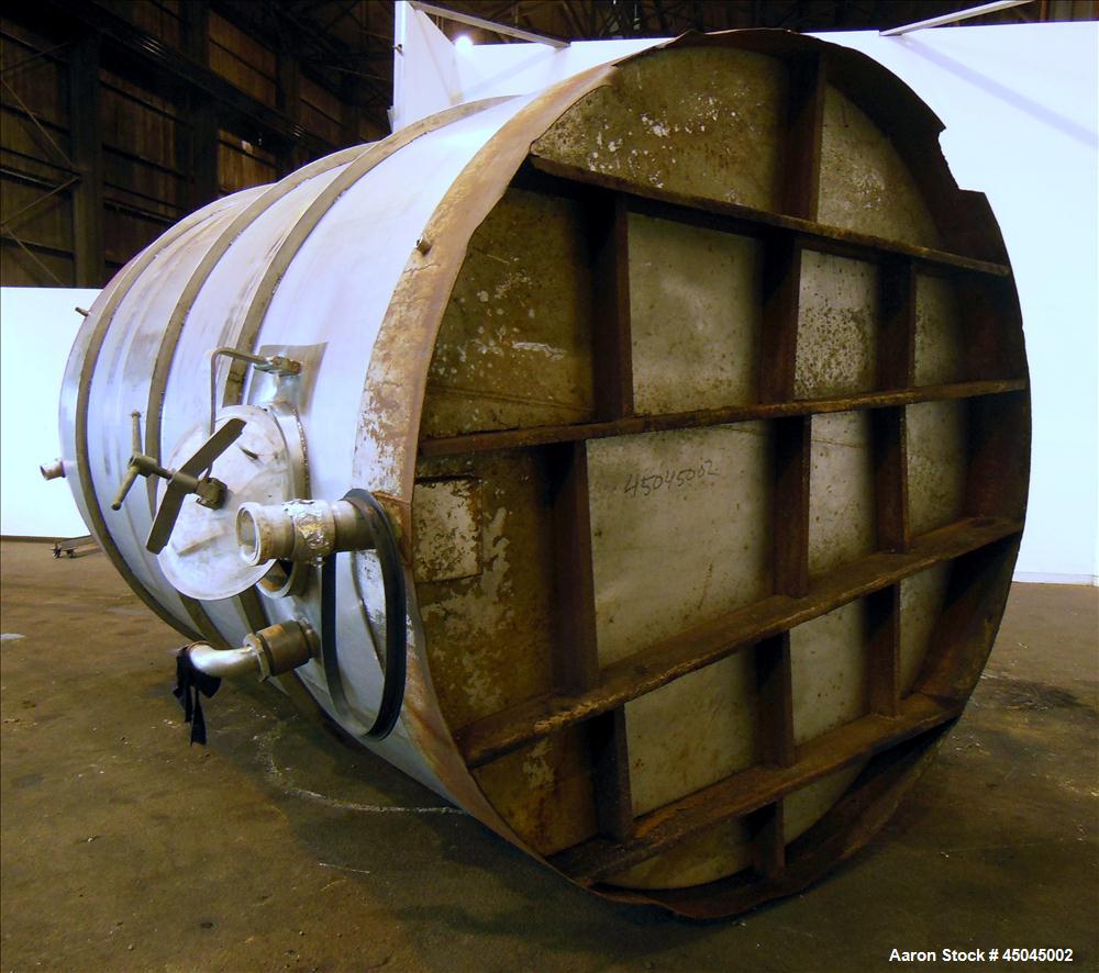 Used Tank, 5,000 Gallon, 304 Stainless Steel, Vertical. Approximate 102" x 142" straight side, slight coned top, sloped bottom. Openings top 3", 3-1/2", 1-1/2", side 16" x 20" oval man way with cover...