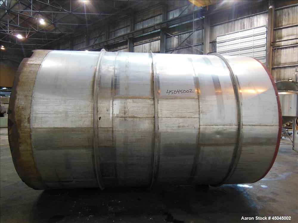 Used Tank, 5,000 Gallon, 304 Stainless Steel, Vertical. Approximate 102" x 142" straight side, slight coned top, sloped bottom. Openings top 3", 3-1/2", 1-1/2", side 16" x 20" oval man way with cover...