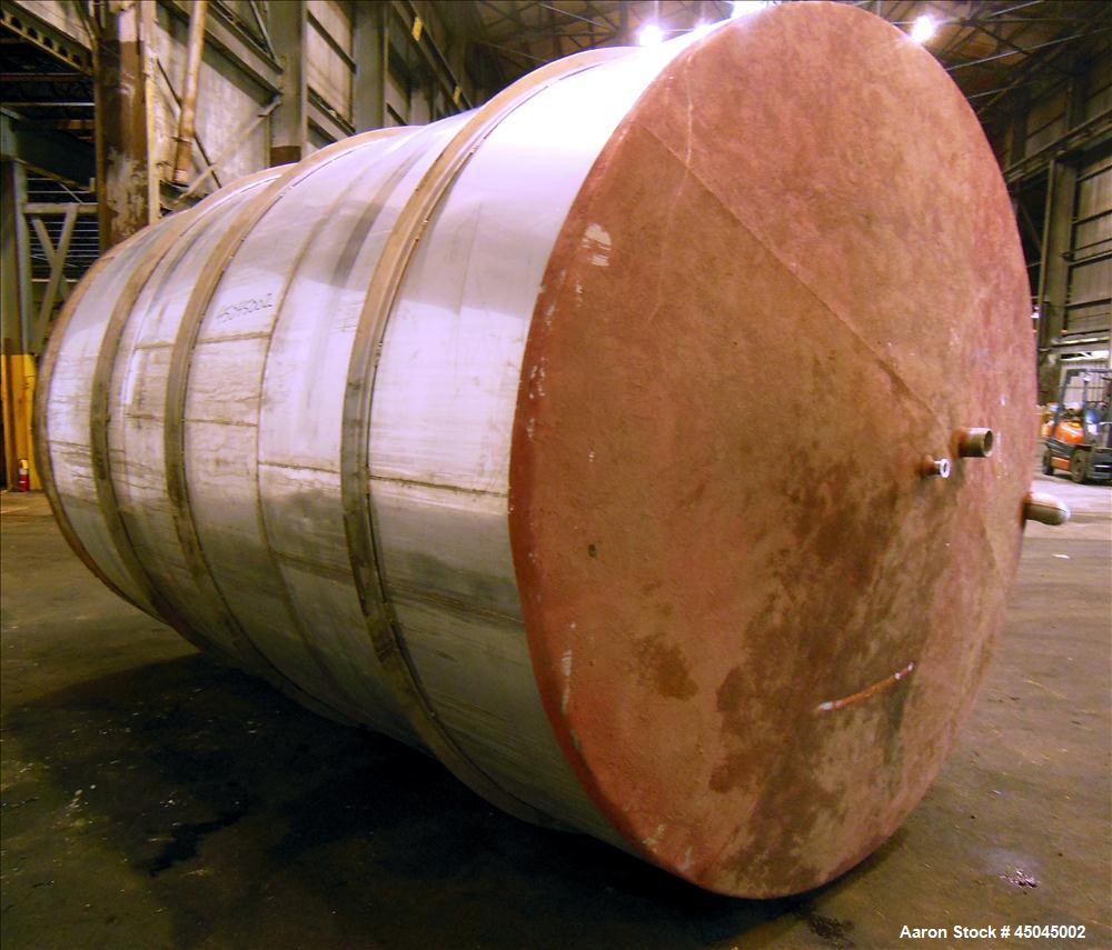 Used Tank, 5,000 Gallon, 304 Stainless Steel, Vertical. Approximate 102" x 142" straight side, slight coned top, sloped bottom. Openings top 3", 3-1/2", 1-1/2", side 16" x 20" oval man way with cover...
