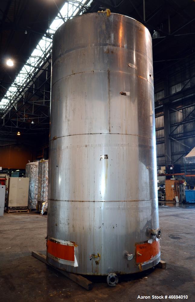 Used Tank, Approximate 6000 Gallon, 304 Stainless Steel, Vertical. Approximate 96" diameter x 192" straight side, coned top, inverted dished bottom. Openings side 16" x 20" oval man way with cover, 3...