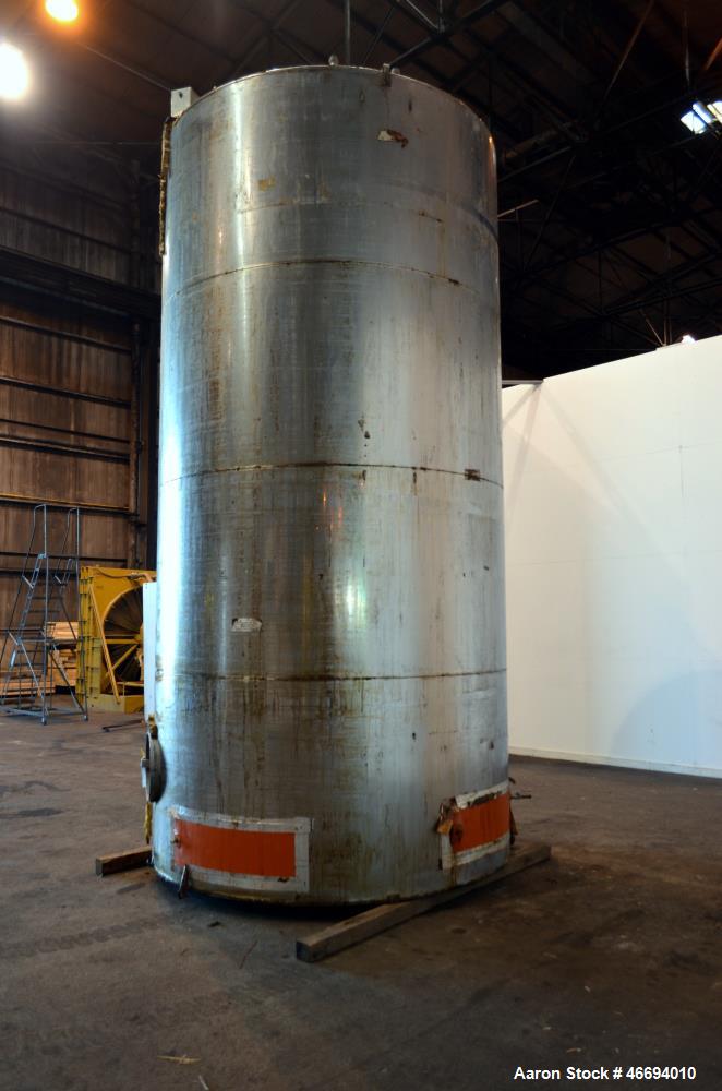 Used Tank, Approximate 6000 Gallon, 304 Stainless Steel, Vertical. Approximate 96" diameter x 192" straight side, coned top, inverted dished bottom. Openings side 16" x 20" oval man way with cover, 3...