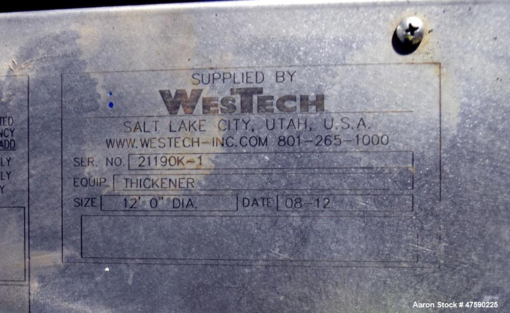 Unused- WesTech Tank, Approximate 7000 Gallon, 316 Stainless Steel, Vertical. 12' Diameter x 8' straight side, flat top, coned bottom. Bridge mounted thickner rake agitator. Mounted on legs.