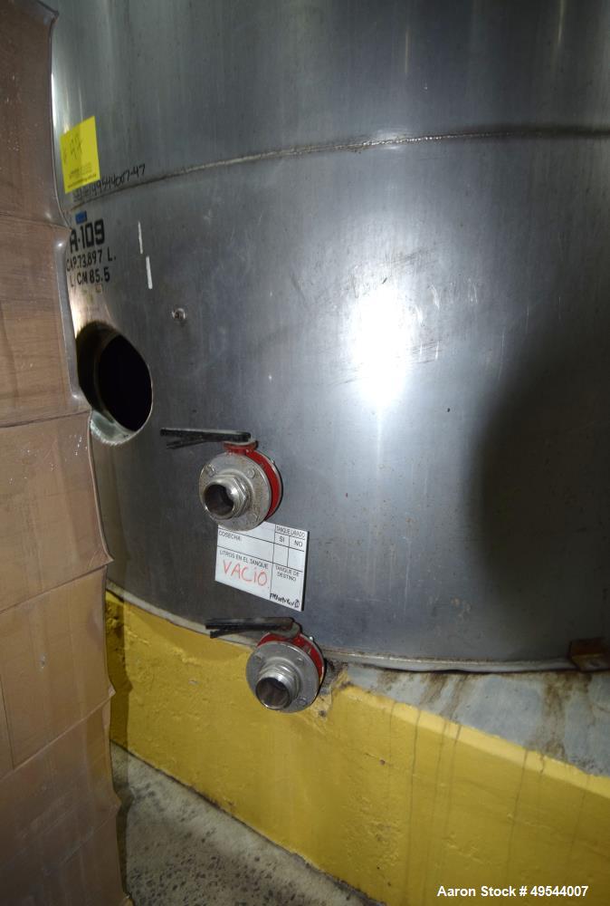 Used Tank, Approximate 19,500 Gallon, 14 Gauge Stainless steel, Vertical. Approximate 130” diameter x 336” straight side, coned top, 7” sloped bottom. Openings top 16” man way with cover and approxim...