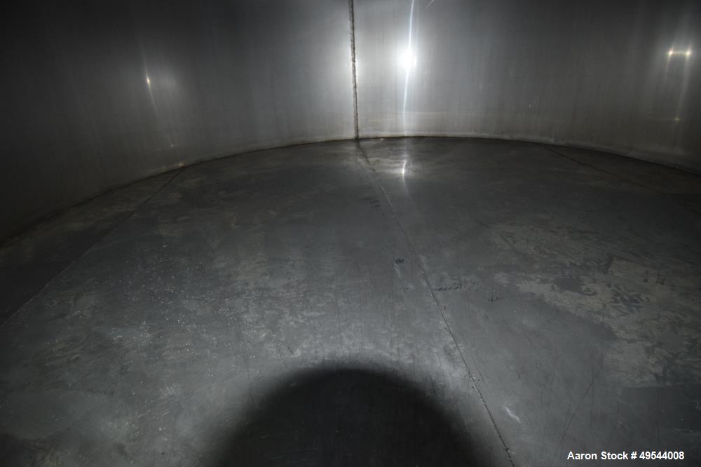 Used Tank, Approximate 19,500 Gallon, 14 Gauge Stainless steel, Vertical. Approximate 130” diameter x 336” straight side, coned top, 7” sloped bottom. Openings top 16” man way with cover and approxim...