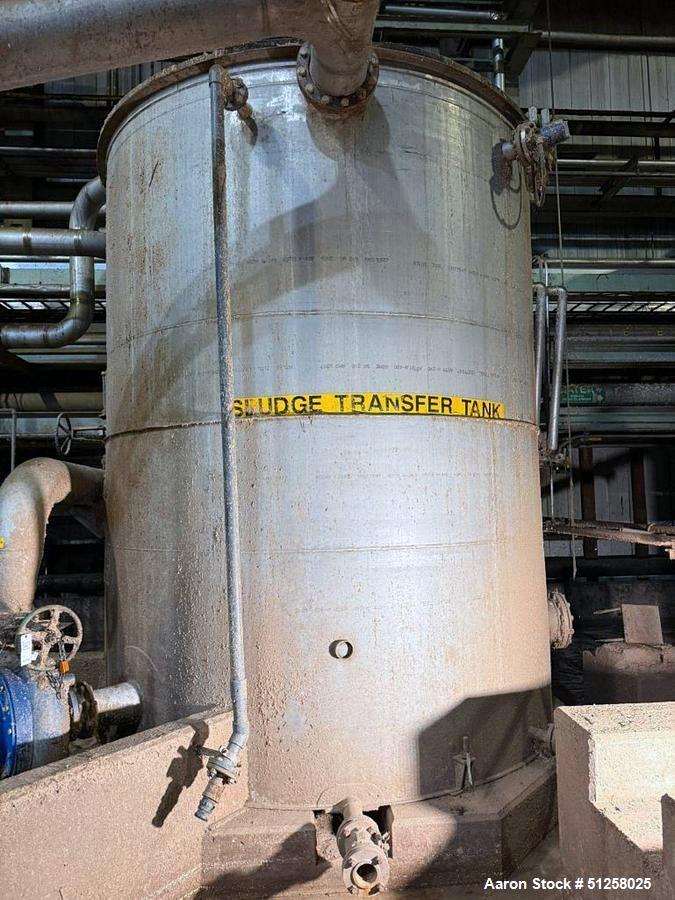 Used 7,600 Gallon Vertical Stainless Steel Tank. 316L Stainless steel. Approximately 10' diameter x 13' tall. Side manway. Side bottom outlet.