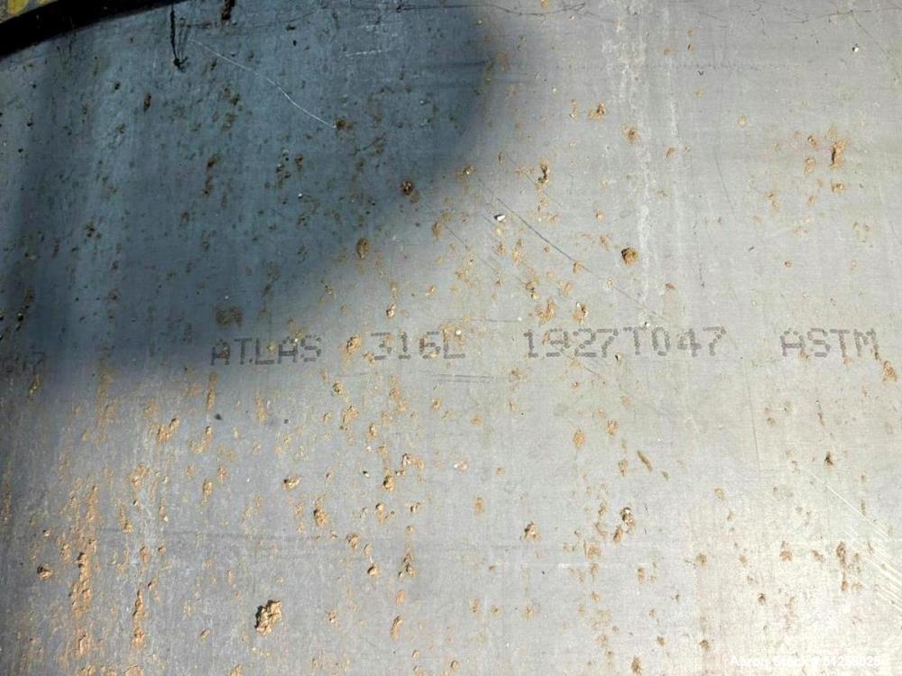 Used 7,600 Gallon Vertical Stainless Steel Tank. 316L Stainless steel. Approximately 10' diameter x 13' tall. Side manway. Side bottom outlet.