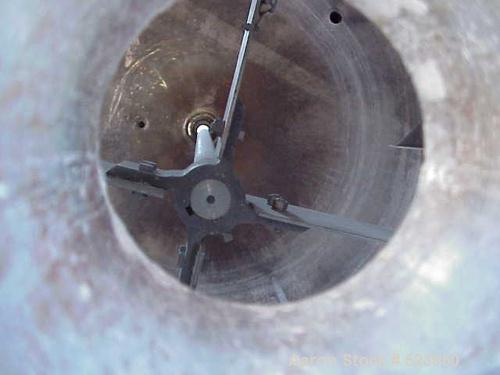 USED: 8000 Gallon vertical, stainless steel, tank. 10'6" diameter x12'. Dish top and bottom. Chemineer mixer model 3HTN-5, 5 hp, 1750rpmi, 68 rpm. Top manway, 4" CBO. Lug mount.
